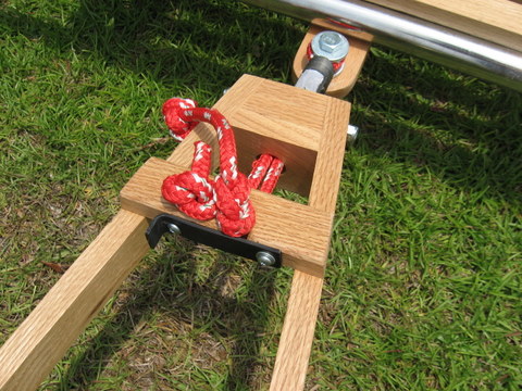 Close-up of tow bar front end attached to the hitch.  Rope loop around the hitch leads through a piece of pipe threded into front block and is secured with stopper knots to the cross-piece.