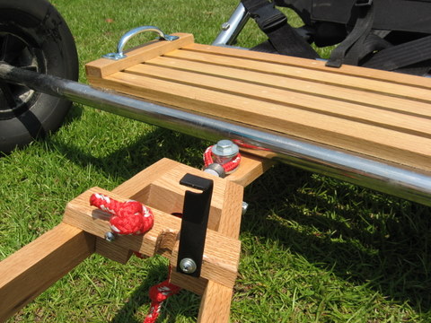 Close-up with swing-clip opened to release the stopper not from the notch, allowing rope to losen and be removed from the hitch.